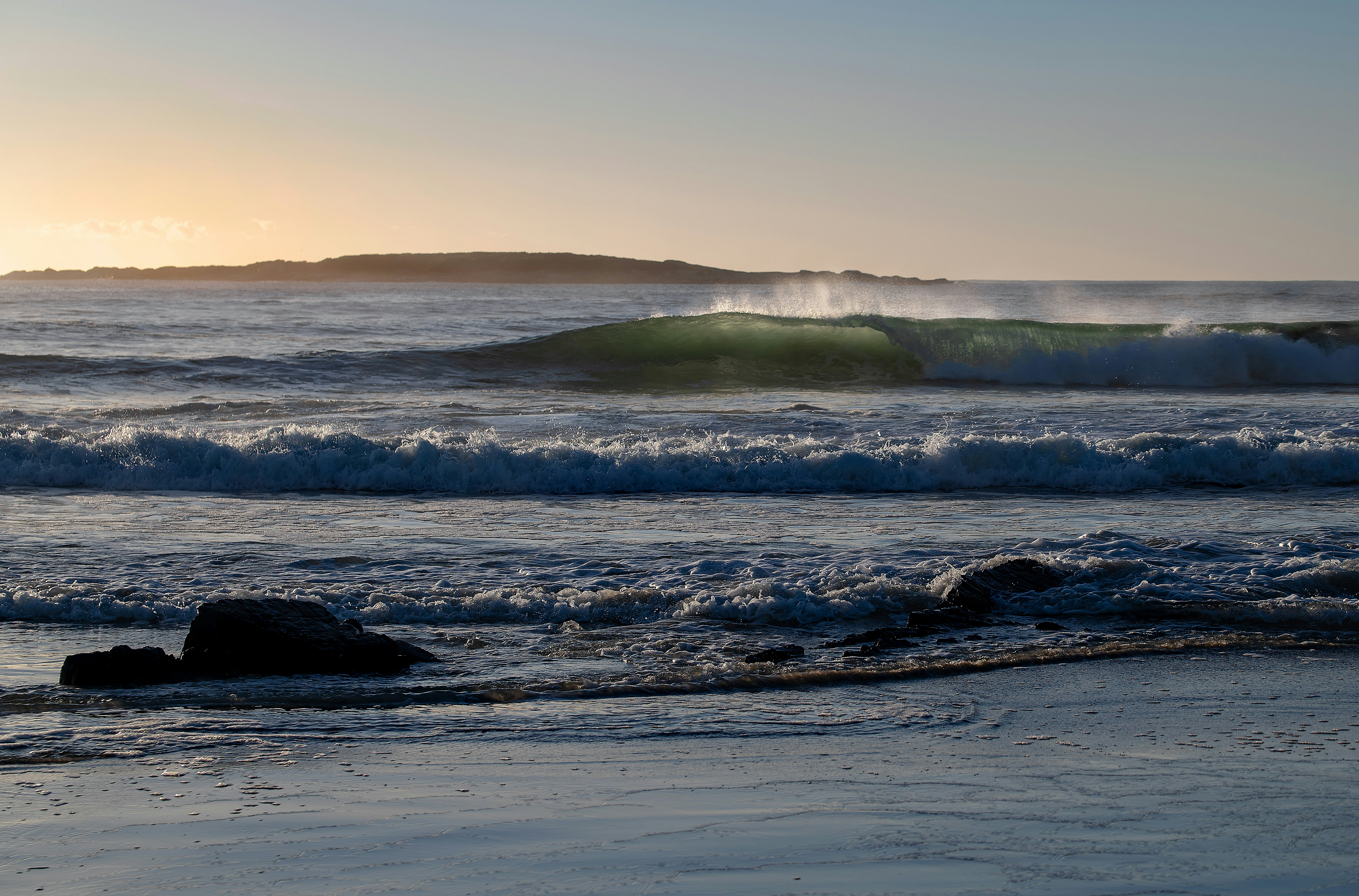 ocean waves crashing on shore during daytime